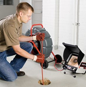 Worker using sewer scope