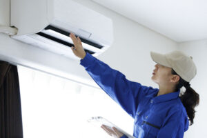 Worker inspecting AC