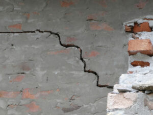 Old damaged wall with a crack line in the brick wall