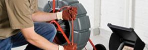 man performing sewer scope on home